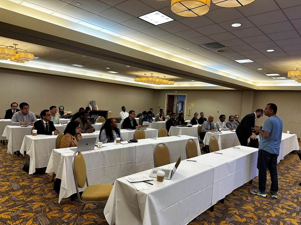 A group of people sitting at tables in a room

AI-generated content may be incorrect.